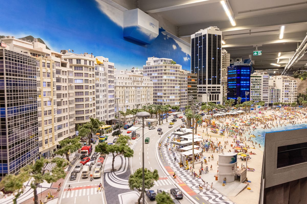A miniature representation of Rio de Janiero, showing skyscrapers, roads, and a beach. The sky is painted on a wall, and a ceiling with lighting is visible overhead.